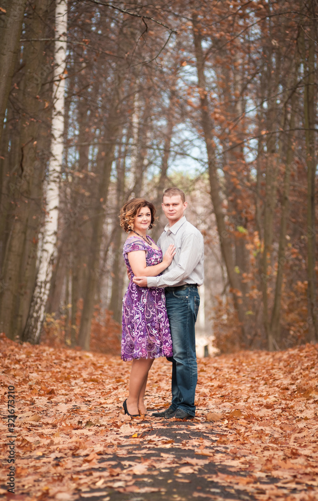 couple in love walks in autumn park couple in love walks in autumn park