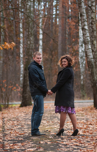 couple in love walks in autumn park © Алексей Бондаренко