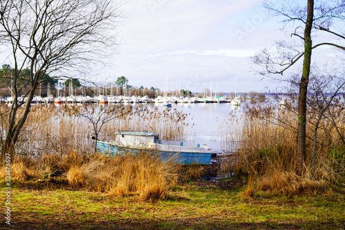 sunrise lake and small boats port Sanguinet Gironde France photo