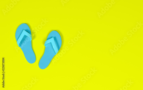 Rubber slippers on pastel background.