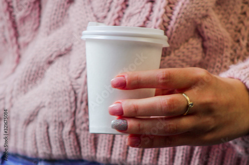 hand holding red cup of coffee