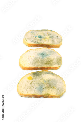 three slices of bread covered with mold isolated on a white background vertical format