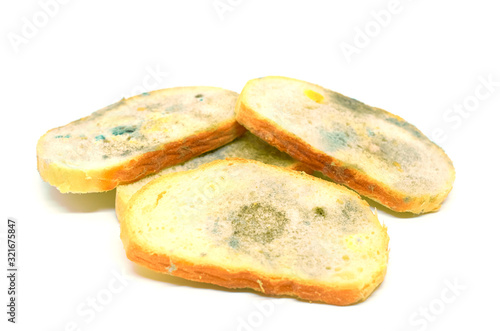 four slices of bread covered with mold isolated on a white background