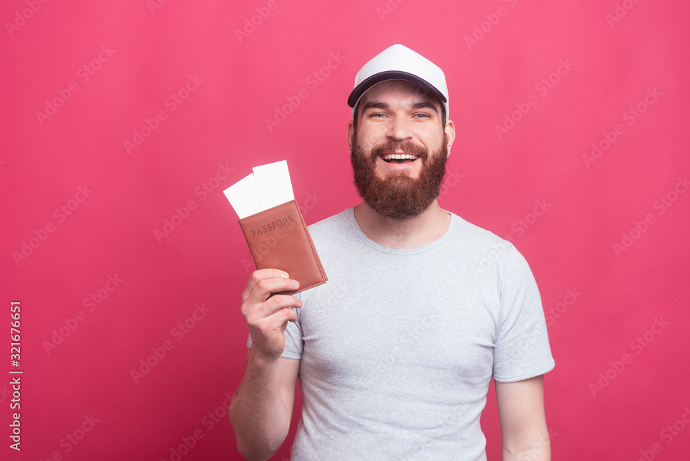 portrait of cheerful man showing ticktes and passport, on the way portrait of cheerful man showing ticktes and passport, on the way