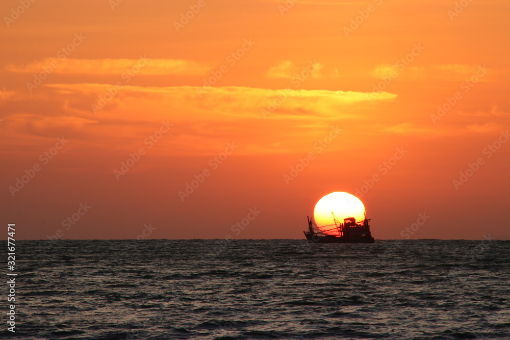 sunset boat over the sea