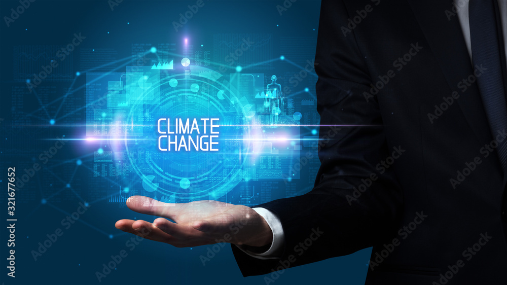 Man hand holding CLIMATE CHANGE inscription, technology concept Man hand holding CLIMATE CHANGE inscription, technology concept