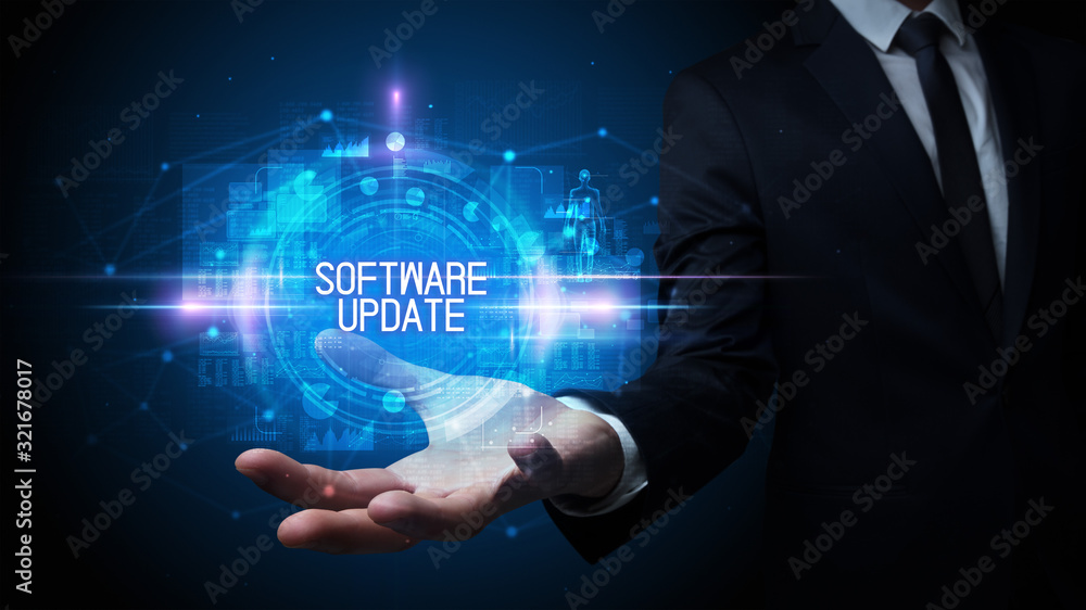 Man hand holding SOFTWARE UPDATE inscription, technology concept Man hand holding SOFTWARE UPDATE inscription, technology concept