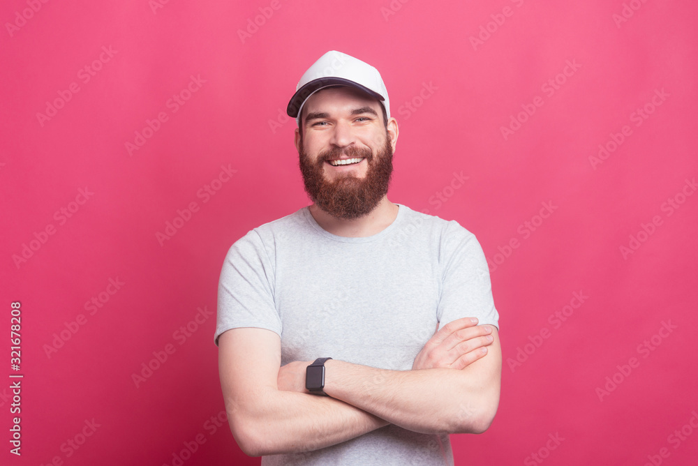 Portrait of happy man with beard with crossed arms looking confident at the camera Portrait of happy man with beard with crossed arms looking confident at the camera