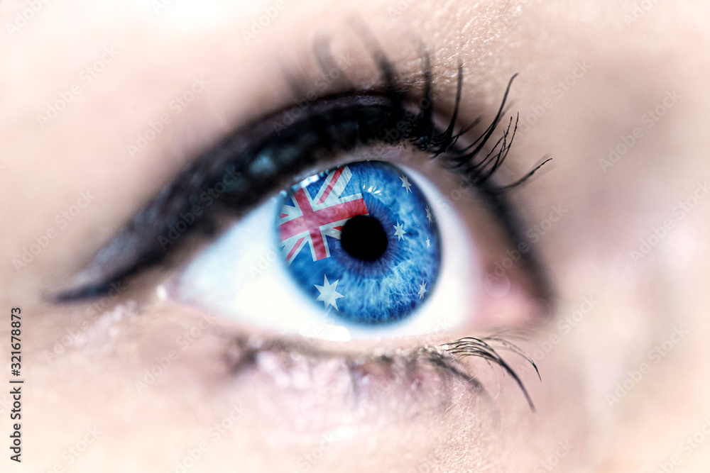 Obraz premium Flag of Australia reflects in a woman blue eye - election, sport, hope, young, generation, pride, dream, emotion, independance 