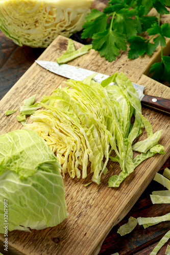Fresh Slice of Cabbage on wooden chopping board. healthy food