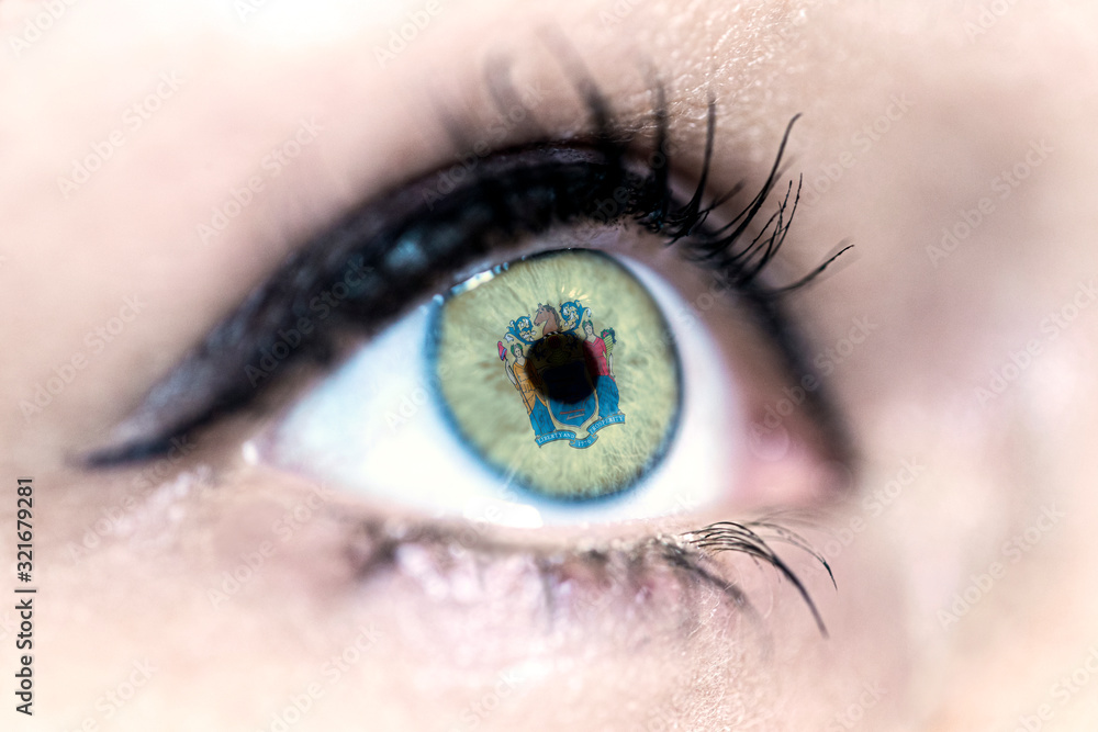 Obraz premium Flag of New Jersey state of the United States of America reflects in a woman blue eye - election, sport, hope, young, generation, american football, basket, emotion
