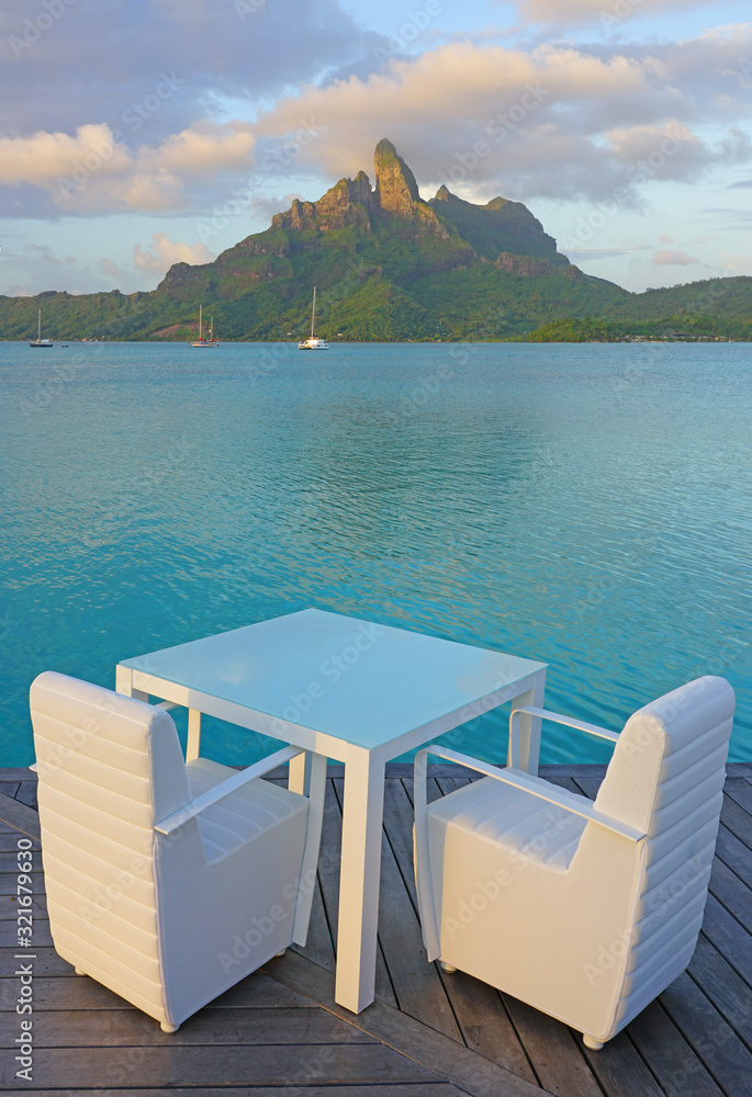 Table and chairs with a view of the Mont Otemanu and the Bora Bora lagoon in French Polynesia