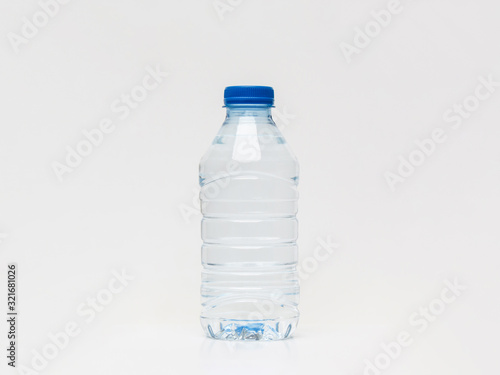 Plastic bottle of still healthy water isolated on white background. Small water bottle.
