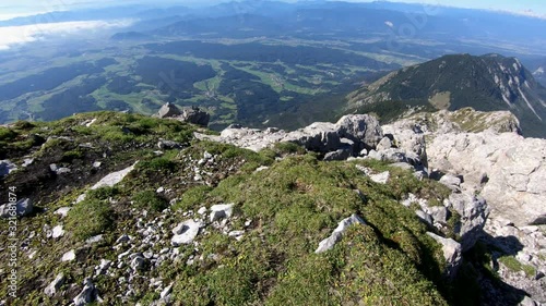 Descending tilt up summit Slovenian Alps mountain covered with green grass photo