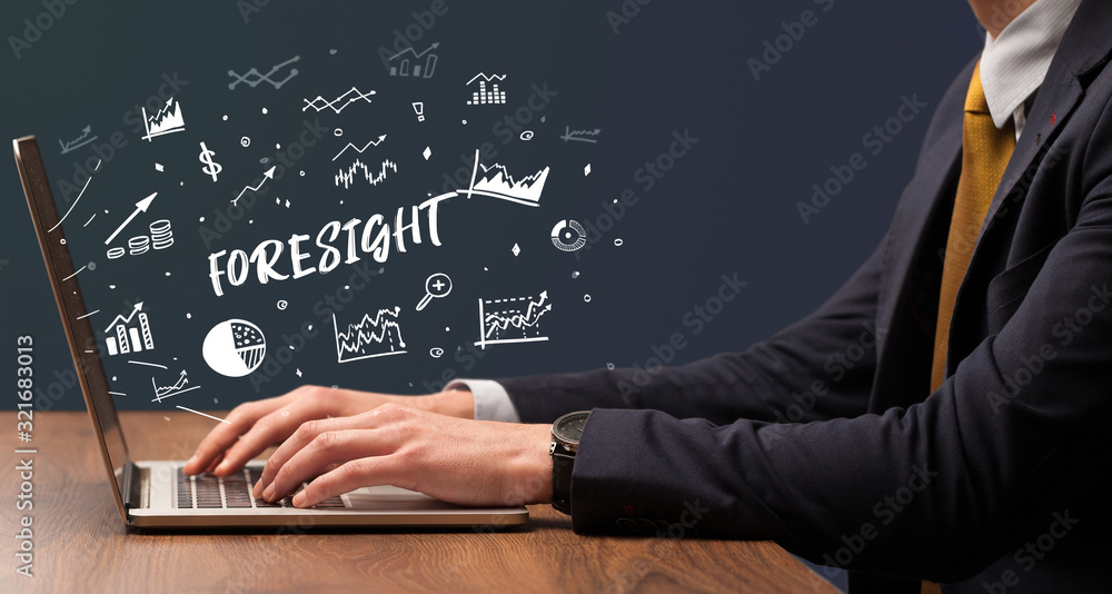 Businessman working on laptop with FORESIGHT inscription, modern business concept Businessman working on laptop with FORESIGHT inscription, modern business concept