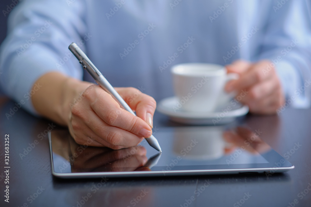 personal finance planning concept, Young woman working with a tablet. Female freelancer connecting to internet via computer. Blogger or journalist writing new article. personal finance planning concept, Young woman working with a tablet. Female freelancer connecting to internet via computer. Blogger or journalist writing new article.