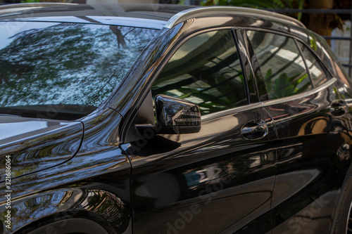 Photography Rear-view mirror or door mirror closed for safety at car park, Side mirror of gr