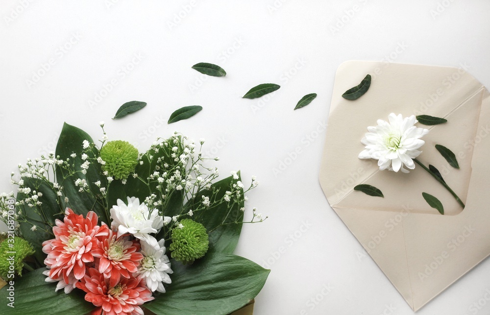 Beautiful spring flowers bouquet with envelope for greetings isolated on white
