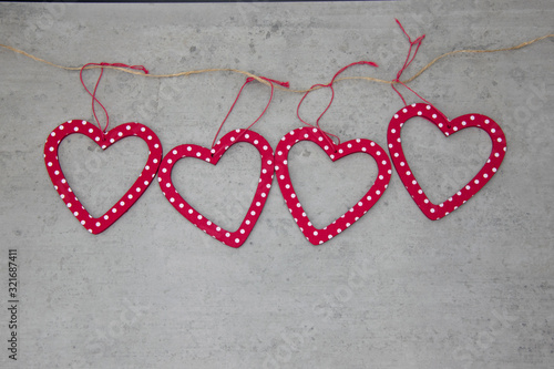 Red hearts with white dots on a Stone background