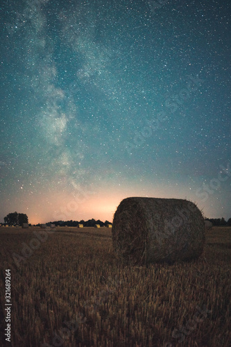 bales of hay in field at night