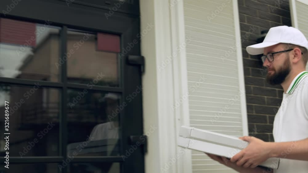 Male courier carrying boxes of pizza. Male courier carrying boxes of pizza.