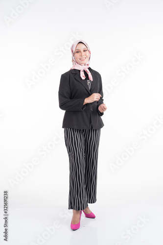 Full length portrait of a beautiful Muslim woman wearing business attire and hijab with mixed poses and gestures isolated on white background. Suitable for technology, business or finance theme.