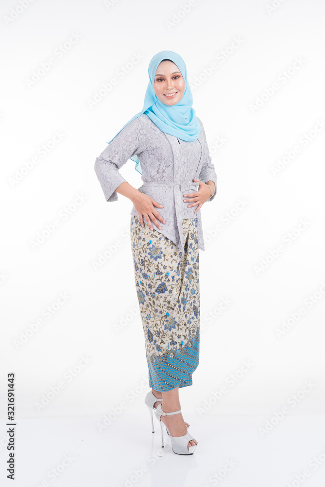 Beautiful female model in poses wearing modern kebaya and hijab, an urban lifestyle apparel for Muslim women isolated on white background. Beauty and hijab fashion concept. Full length Beautiful female model in poses wearing modern kebaya and hijab, an urban lifestyle apparel for Muslim women isolated on white background. Beauty and hijab fashion concept. Full length
