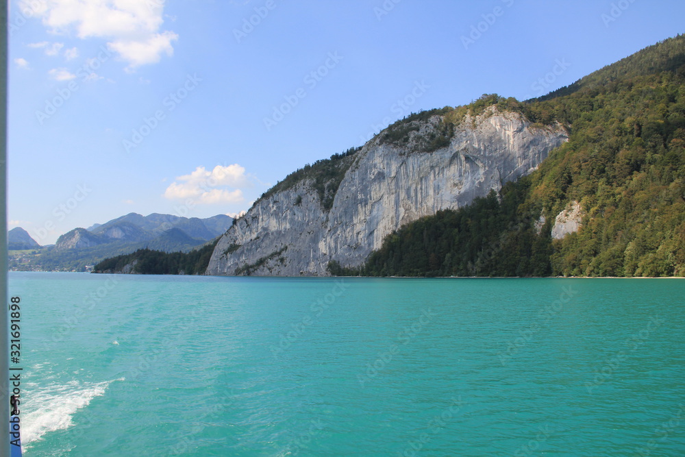 Fototapeta premium cliffs on blue lake in mountians