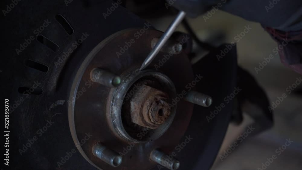 Auto mechanic cleans parts from rust. Car service. Slow motion. Auto mechanic cleans parts from rust. Car service. Slow motion.