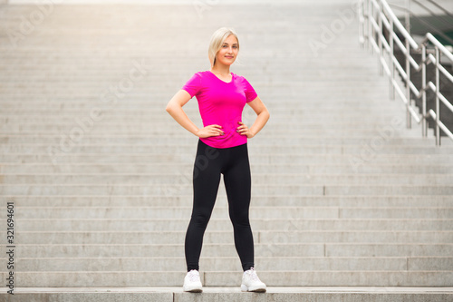 beautiful young woman in sportswear in the summer on the street