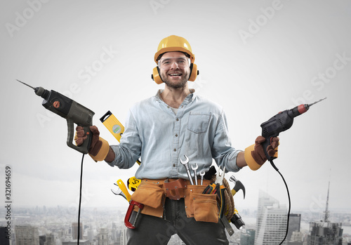 Construction worker with a hammer and drill at work photo