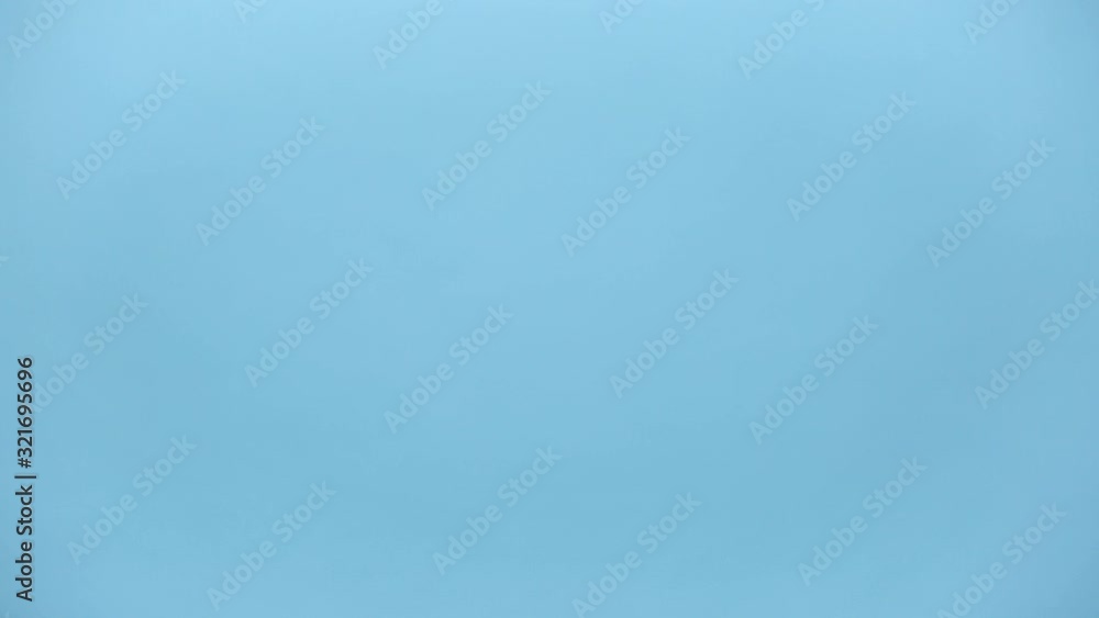 Close up male hold in hand give guy classic red striped xl bucket with tasty popcorn isolated on pastel blue background studio. Cinematography production takeaway out food concept. Copy space mock up Close up male hold in hand give guy classic red striped xl bucket with tasty popcorn isolated on pastel blue background studio. Cinematography production takeaway out food concept. Copy space mock up