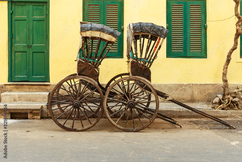 Hand pulled rickshaws are parkedon the street. Kolkata. India