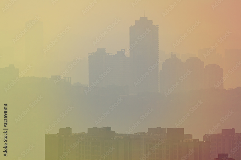 Blurred cityscape in sunset haze. Chinese city of Chongqing. For a beautiful background, postcard, banner.