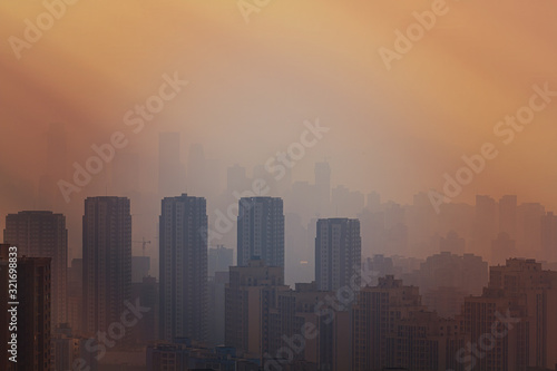 Blurred China cityscape in sunset haze. Chinese city of Chongqing. For a beautiful background, postcard, banner.