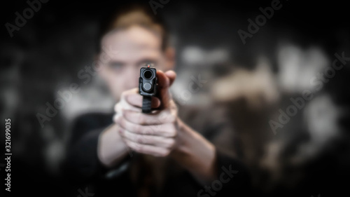 Man holding gun preparing to shoot. Personal defense concept.