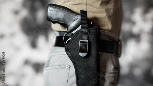 Man openly carrying a revolver on his belt. Open carry and second amendment concept.