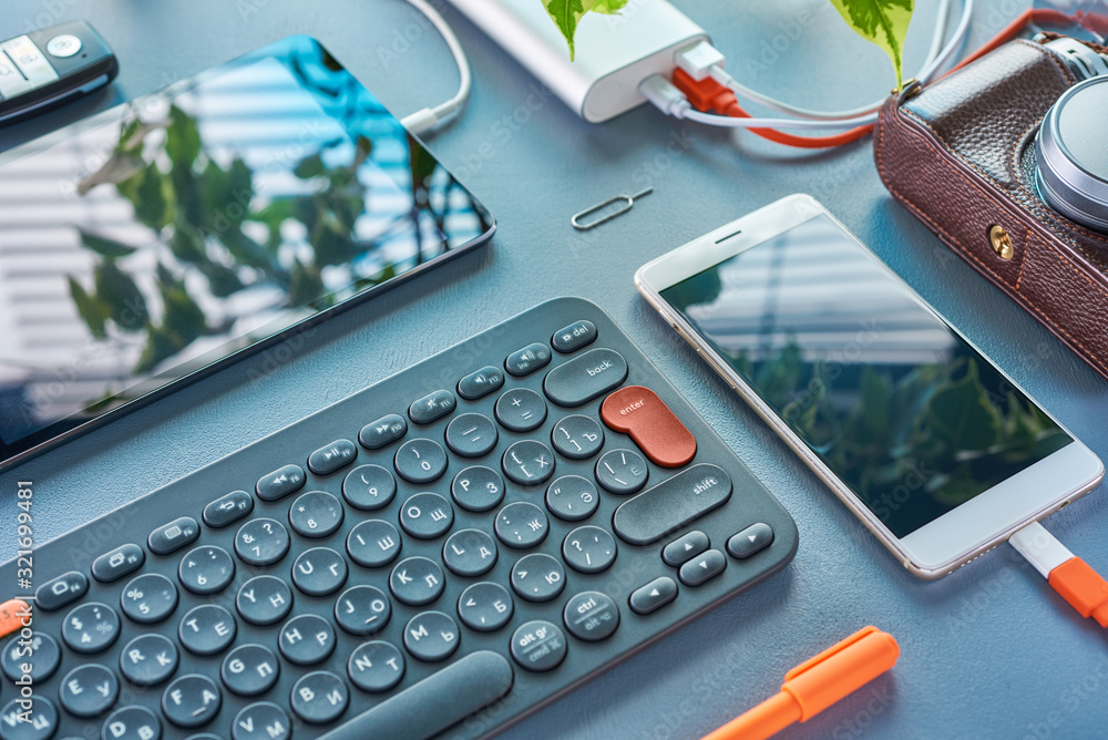 Mobile devices the phone, tablet, keyboard, and usb stick are on the