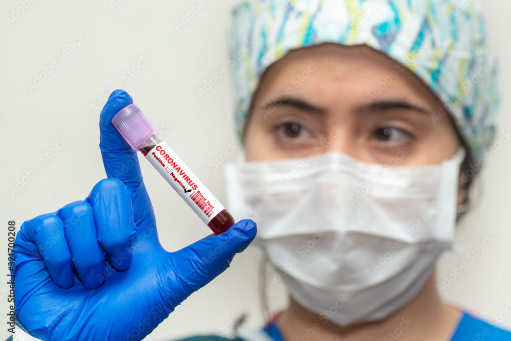 Nurse holding test tube with blood for 2019-nCoV analyzing. Coronavirus negative blood in laboratory. Nurse holding test tube with blood for 2019-nCoV analyzing. Coronavirus negative blood in laboratory.