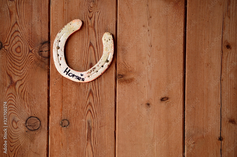 old horseshoe on wooden door old horseshoe on wooden door