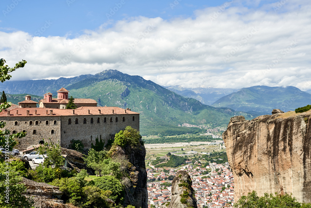 Obraz premium Amazing Meteora Monastery in Greece. Fantastic view at mountains and green forest against epic blue sky with clouds. UNESCO