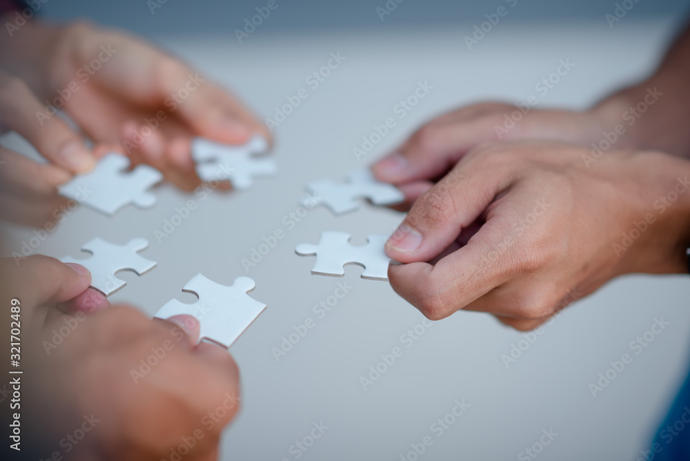 Business people and puzzle teamwork concepts Business people and puzzle teamwork concepts