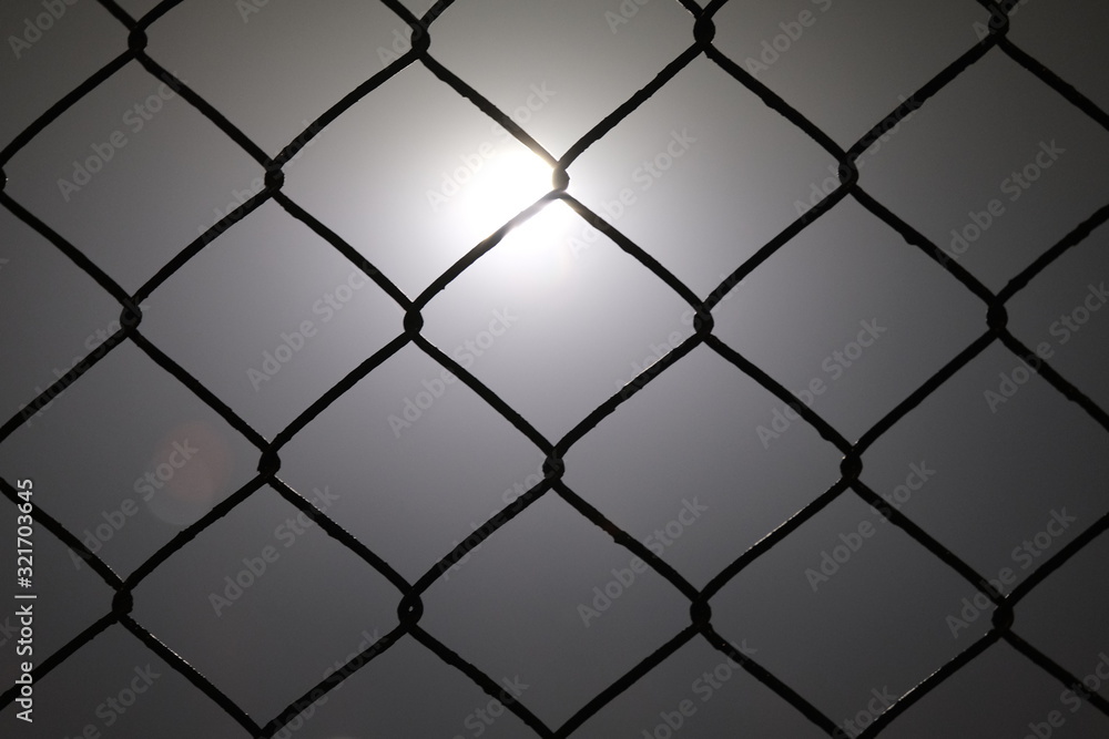 Metal wire in foggy night with light in background Metal wire in foggy night with light in background