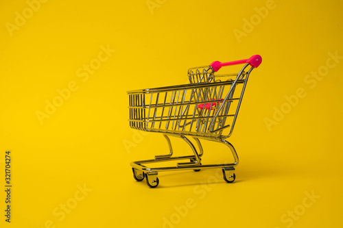 shopping cart isolated on yellow background isolate