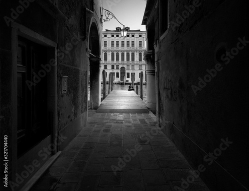Walking along the black and white streets of Venice. Italy.