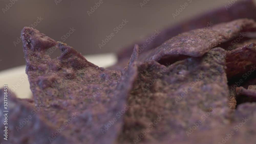 Delicious close up on a bunch of crispy, crunchy, blue nachos.