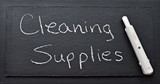Cleaning supplies written in white chalk on blackboard