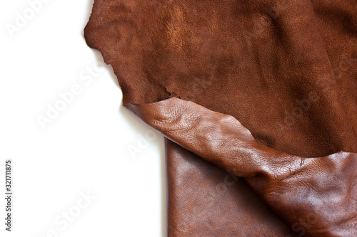 Leather in roll isolated on white background. Piece of brown leather isolated on white
