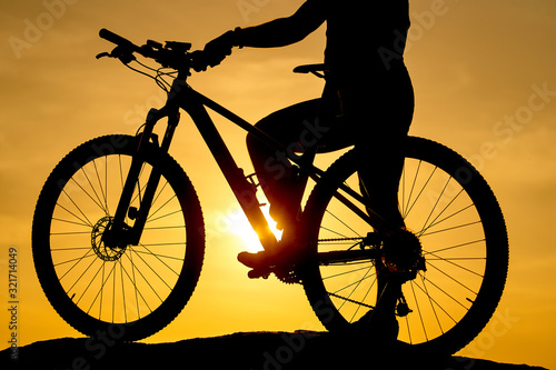 Silhouette of a bike on sky background on sunset. Detailed photo. Closeup
