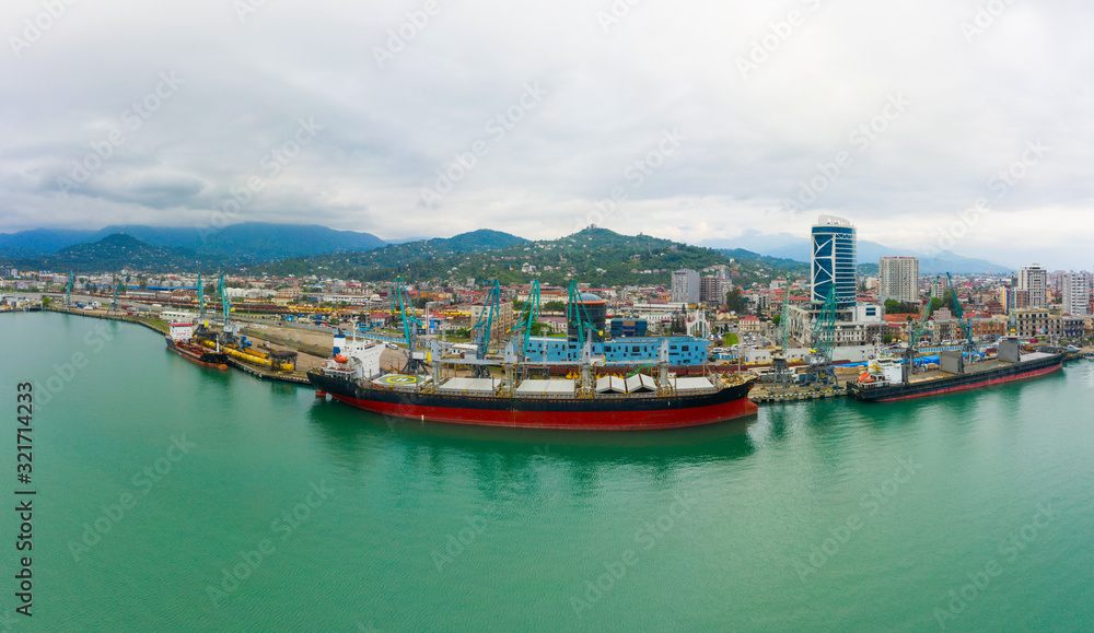 Bulk cargo ship under port crane, Batumi seaport, Georgia.